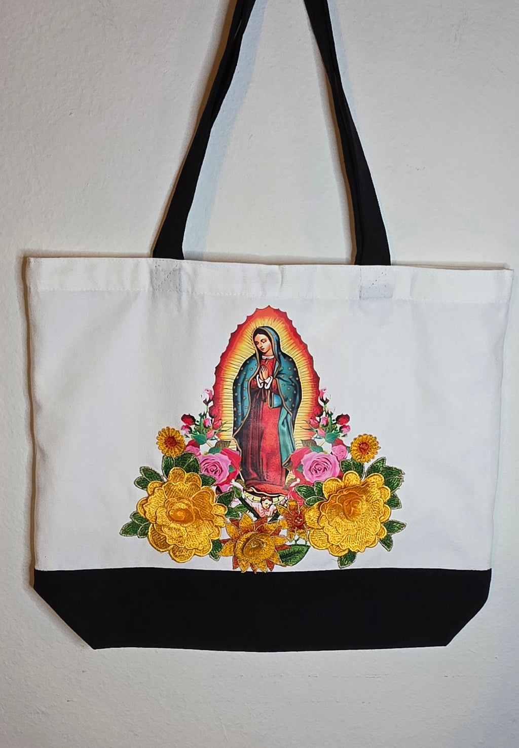 Our Lady Of Guadalupe image with 3D flower appliqués on a spacious, high-quality canvas tote bag.