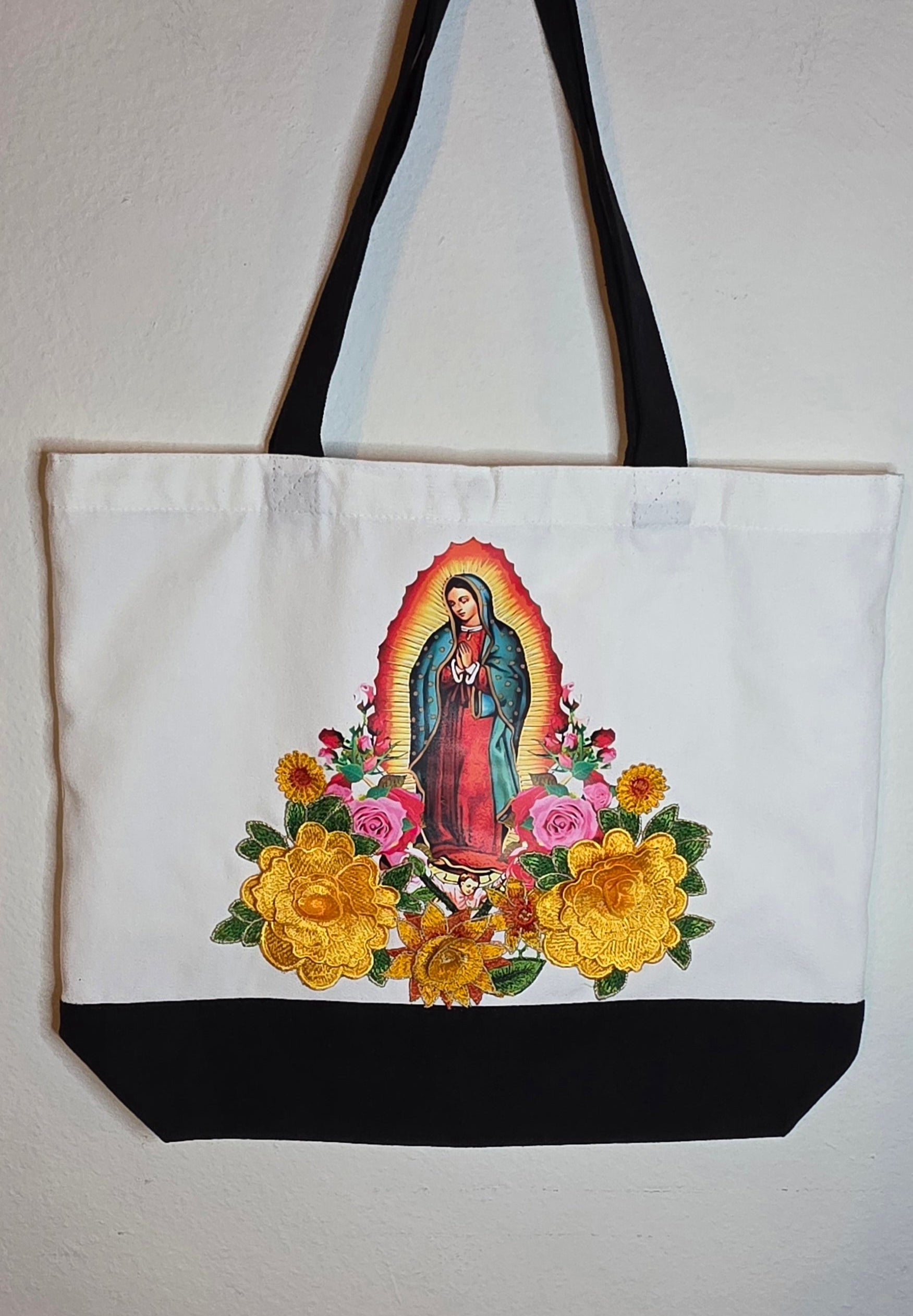 Our Lady Of Guadalupe image with 3D flower appliqués on a spacious, high-quality canvas tote bag.